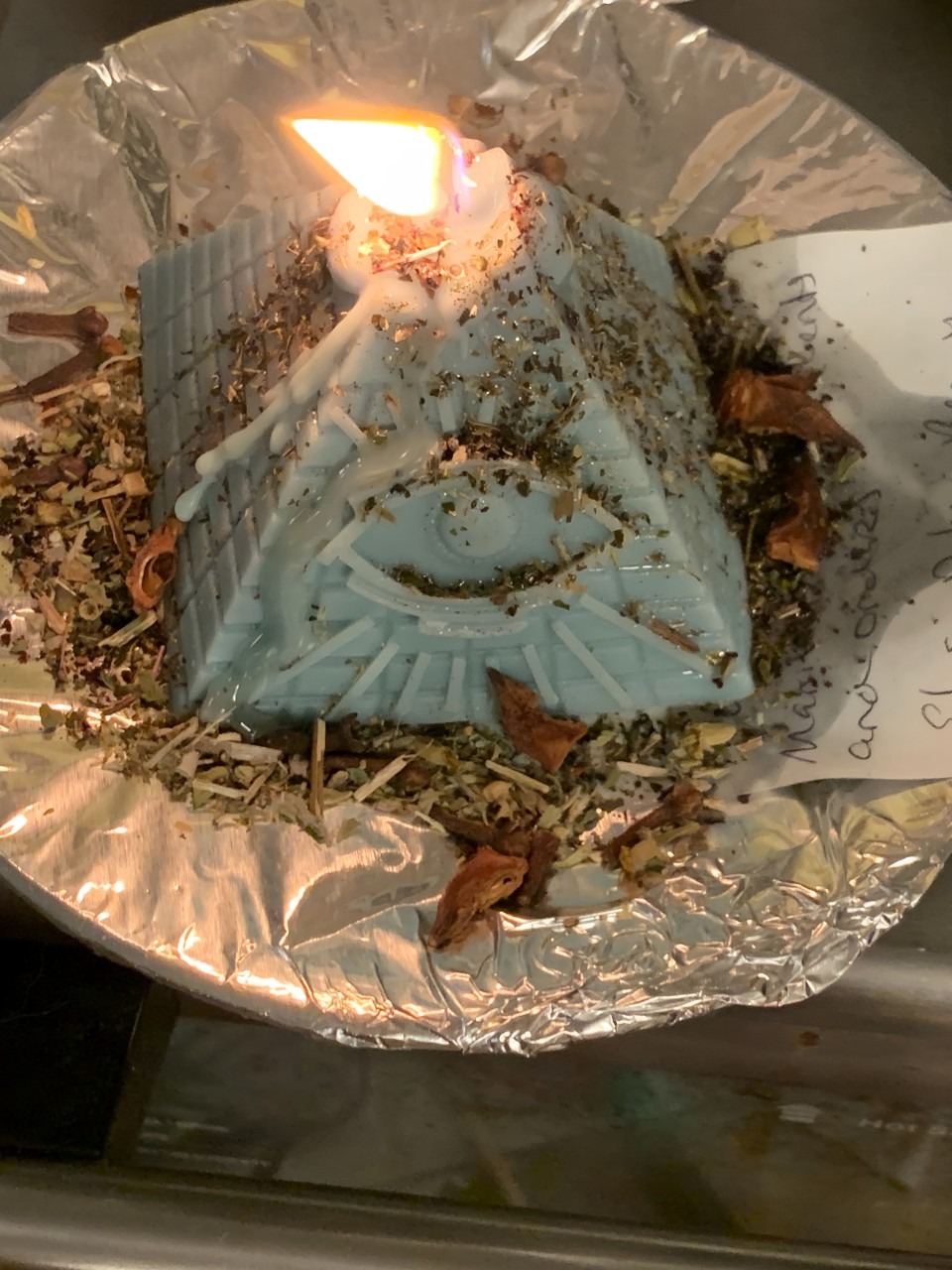 A Candle on a Plate With a Note Beside It