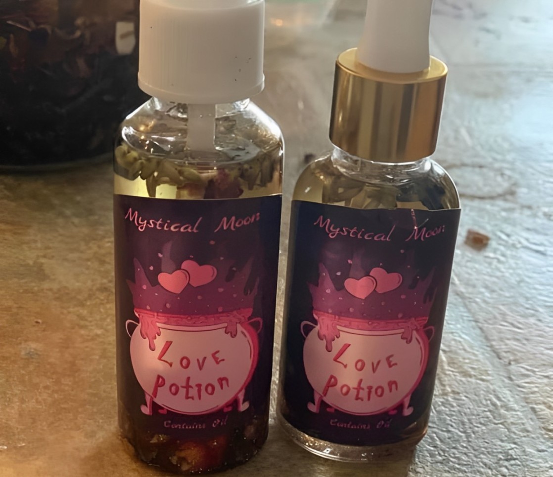 Two bottles of colorful love potion sit on a wooden counter