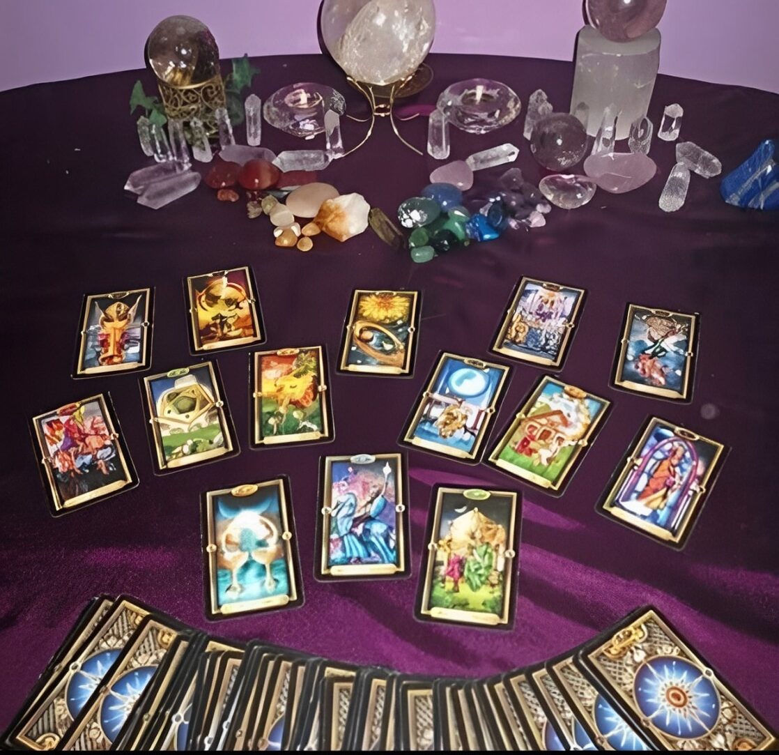 A Table Displaying Tarot Cards, Candles, and Crystals, Creating a Mystical Atmosphere for Readings.